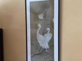 a picture of two birds hanging on the wall
