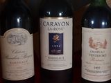 three bottles of wine are lined up on a table