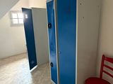 a red chair sitting in the corner of a room