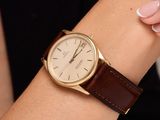 a woman that is holding a watch on her wrist
