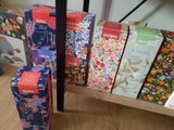many boxes of tea on a shelf next to each other