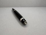 an image of a pen laying on top of a white surface