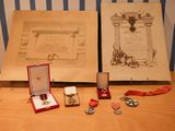 two medals and a medal on a table next to an open book