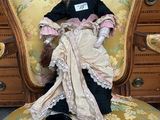 a doll that is sitting on a chair in a room