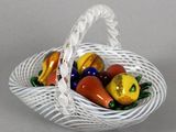 a white basket filled with fruit and vegetables on a table