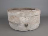 a stone bowl with a fish design on it