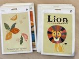 two cards with a picture of a lion on them