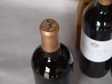 two bottles of wine sitting next to each other on a table