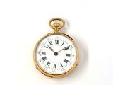 a gold pocket watch with roman numerals on the face
