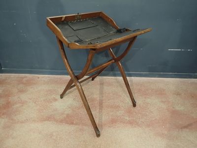 a small wooden tray with a leather seat on a stand