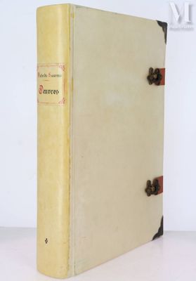 un vieux livre posé sur une table à côté d'un mur blanc