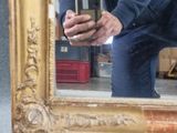 a man that is taking a picture of himself in a mirror