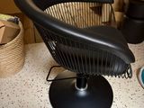 a black chair that is sitting on a table