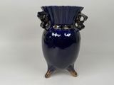 a blue vase that is sitting on a table