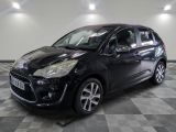 la voiture noire est garée sur un sol en damier dans le garage