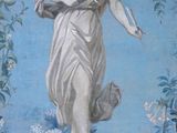 a painting of a woman holding a book on a wall