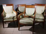 two wooden chairs with striped upholstered upholstered cushions