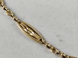 a close up of a gold bracelet with a long chain