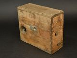 an old wooden box sitting on top of a black surface