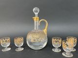 four glasses and a decanter on the table