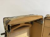 an open suitcase sitting on top of a wooden table
