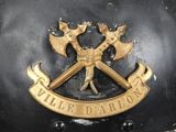 a close up of a helmet with two crossed axes on it