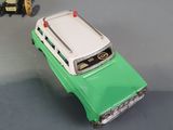 two toy cars sitting next to each other on a table