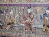 a picture of a wall hanging with a group of people on it