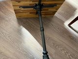 a wooden table with a metal tripod on top of it