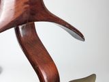 a wooden and brass sculpture of a bird on a stand