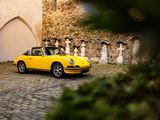 a yellow car that is parked in front of a building