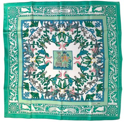 a green and white scarf with birds and flowers on it