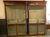 two glass display cases in the middle of a room