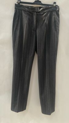 a black and white striped pants hanging on a hanger