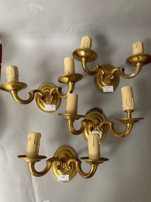 a wall mounted candle holder and a wall sconce on the wall
