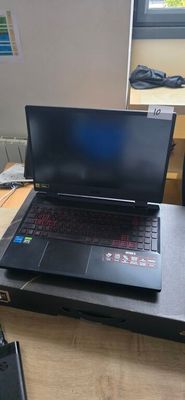 a laptop computer sitting on top of a wooden desk