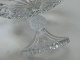 a clear glass bowl with a flower on it