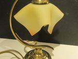 a lamp that is sitting on a table next to a wall