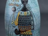 a blue vase with a picture of a man on it