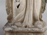an old statue of a woman holding a baby in her arms