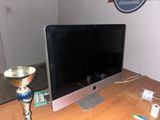 a computer monitor sitting on a desk with a trophy