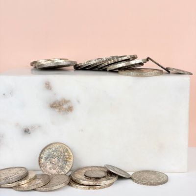 a marble block with a bunch of coins on it
