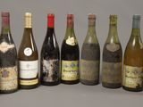 several bottles of wine are lined up in a row