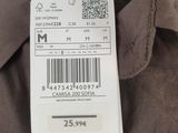 the back of a brown shirt with a white tag on it