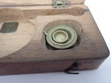 a small wooden box with a button on it