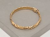 an image of a close up of a gold ring on a table