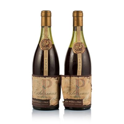 two bottles of wine sitting next to each other on a white surface