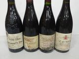 four bottles of wine are lined up on a table