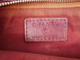 the inside of a pink purse with a tag on it
