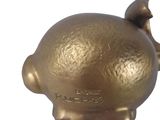 a gold piggy bank sitting on a white surface